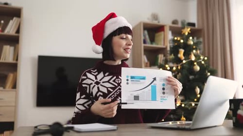 Business Woman Giving Presentation in a Christmas Hat