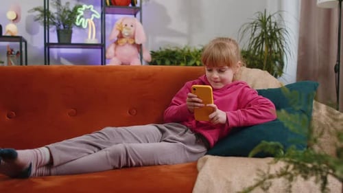 Girl Lying on Couch Using Mobile Phone