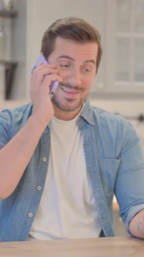 Smiling Adult Man Talking on Phone Indoors
