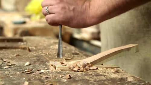 Hands Chisel Wood in Woodworking Workshop