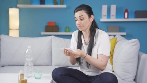 Woman covering her mouth and nose while coughing.