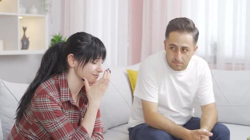 The couple is sad and unhappy at home.