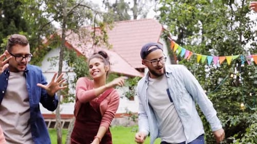 Friends Dancing at Outdoor Garden Party Celebration