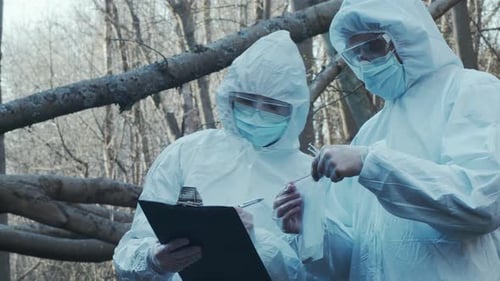 Forensic Specialist Working in the Forest Police Criminalists Collecting Evidence and Making