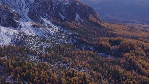 Aerial view of snowy Dolomites mountain peaks in autumn, Italy.