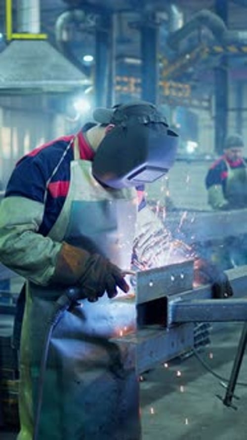 Skilled Welder Crafting Metal Structure in Industrial Workshop