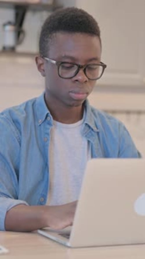 Man Working on Laptop at Desk Indoors