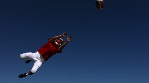 Football Player Catches Ball,