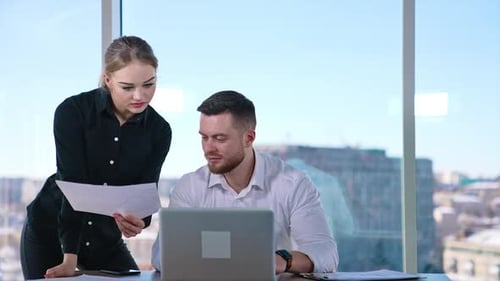 Young business people working in office. Handsome businessman talking