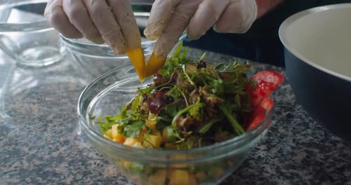 Preparing a Fresh Salad with Mango and Vegetables