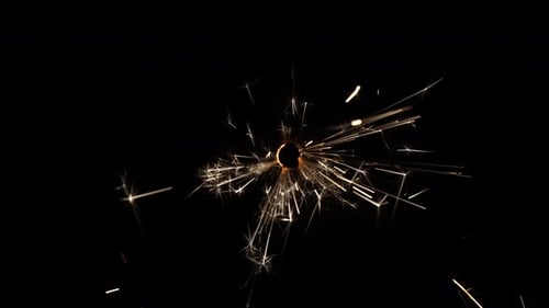 Sparkler Burning Brightly with Golden Sparks on Black