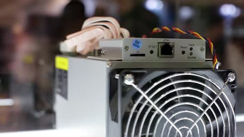 Cryptocurrency Mining Equipment ASIC Application Specific Integrated Circuit on Farm Stand at Expo