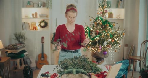 Woman Preparing Christmas Wreath Garland For Christmas Holidays