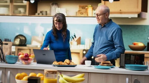 Senior Couple Dancing in Kitchen, Sharing a Romantic Moment