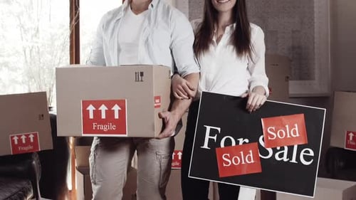 Young Couple with Boxes Moving into New Home
