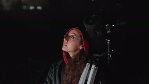 Young Woman with Telescope Looks to the Sky