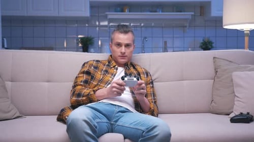 Man Relaxing on Couch Playing Video Game