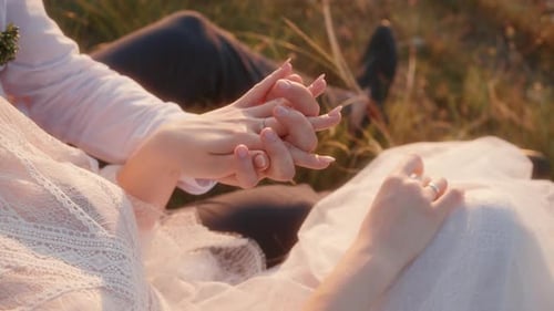 Bride and Groom Holding Hands at Sunset