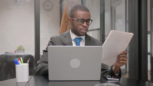 Excited Businessman Celebrating Success in Urban Office