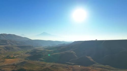 A mountain range with a clear blue sky in the background