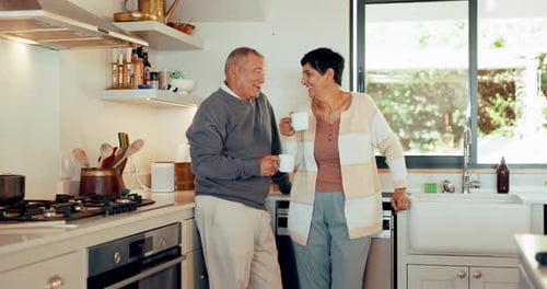 Senior Couple Enjoying Morning Coffee in Kitchen
