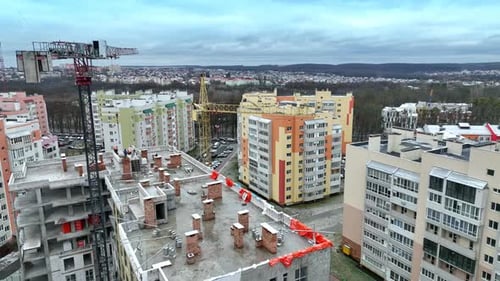 Construction cranes towering above the house in construction.