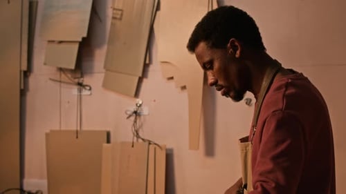 Man Inspecting Leather in Workshop