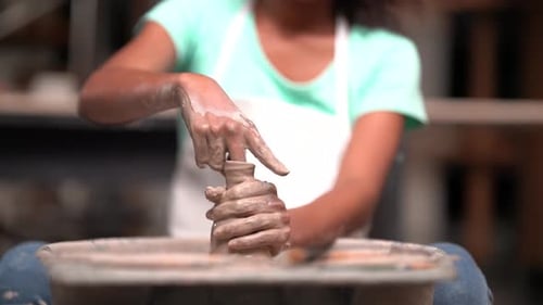 People Creating Pottery in Studio. Female artisan creating handmade ceramics in pottery workshop