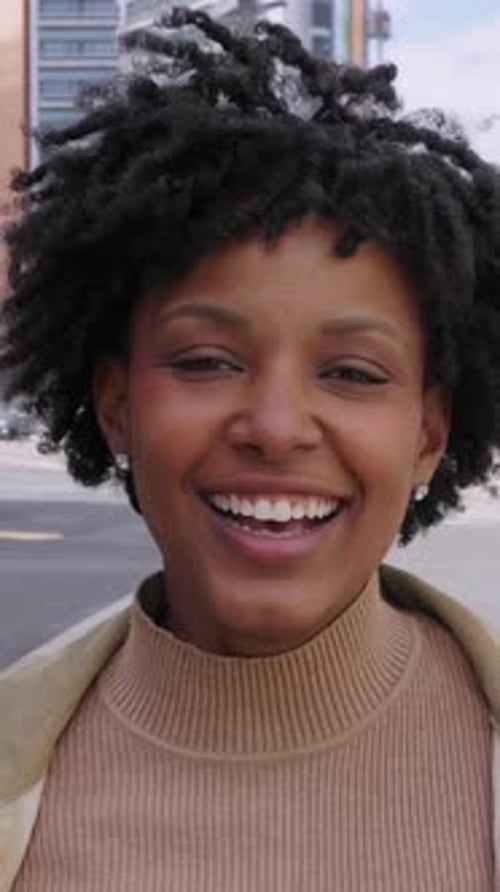 Happy Young African American Girl Smiling at Camera Standing at City Street