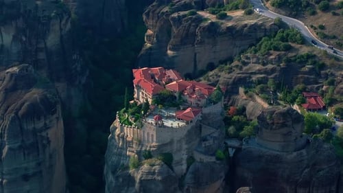 Aerial Footage Capturing a Historic Monastery Perched Atop Dramatic Rock Formations in Meteora