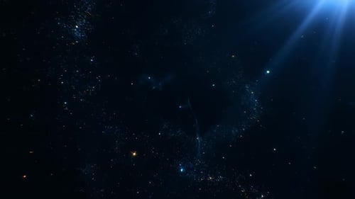 Shimmering blue particles creating a sparkling dust with light rays shining from above.