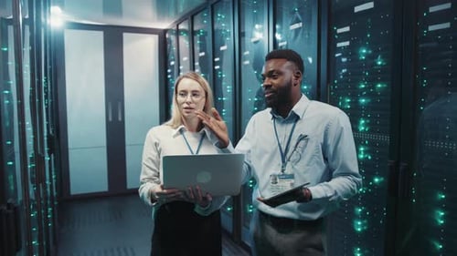 IT Professionals Discuss Data in Server Room