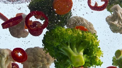 Tasty Healthy Veggies Dropped Transparent Water on White Background Close Up. Fresh