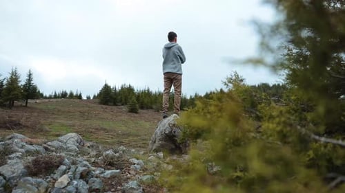 Sad Young Man Alone in Peaceful Forest