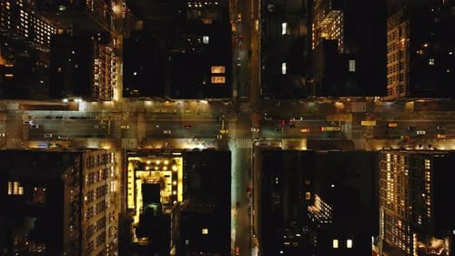 Aerial Views Capture Cars Navigating a Manhattan New York City Intersection at Night Showcasing