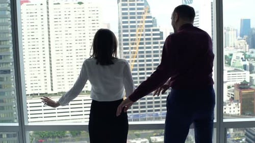 Businesspeople Dancing by Window in Office Apartment
