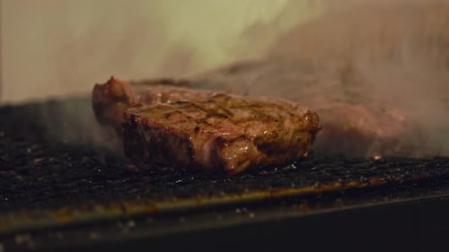 Sizzling Beef Perfection: Close-Up of a Juicy Steak Grilling to Flavorful Excellence