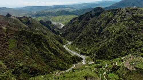 River Flowing In The Middle Of The Mountains Aerial View