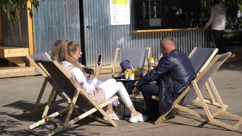 Friends Drinking Coffee at Outdoor Coffee Shop