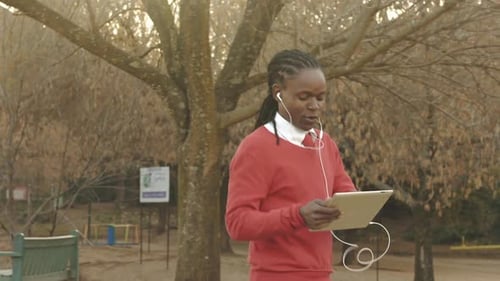 Young Man Video Calling on Tablet in Park