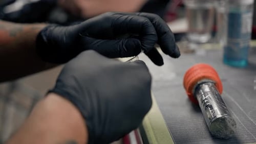 Tattoo Artist Preparing Tattoo Needle