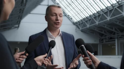 Busy bank entrepreneur answers journalists questions at corporate press conference