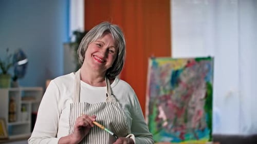 Senior Woman Smiling in her Cheerful Art Studio