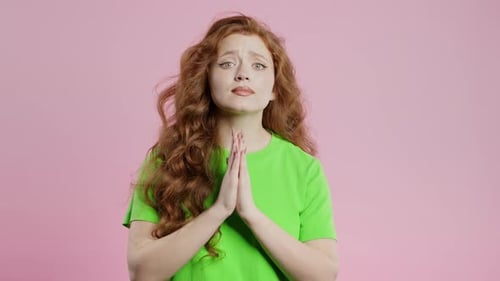 Woman With Clasped Hands Asking For Something