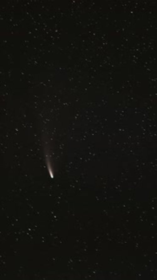 Dazzling Comet Streaking Through the Starry Night Sky