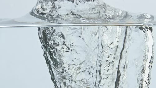 Lemon Splashing into Water Creating Bubbles