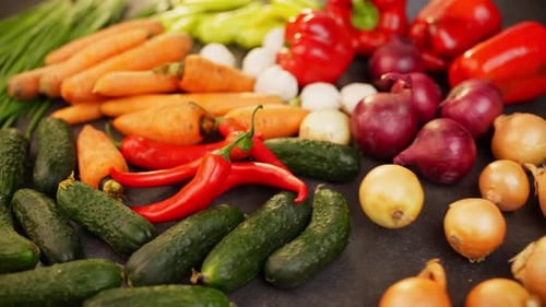 Fresh Vegetables: Carrots, Peppers, Cucumbers, and Onions