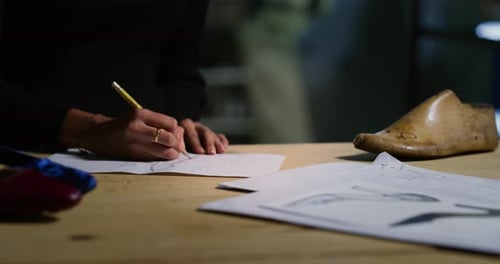 Artist Drawing Shoe Sketch at Workplace