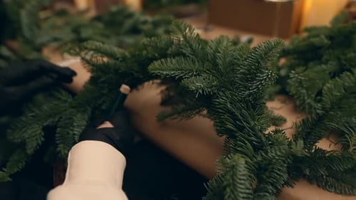 Christmas Wreath Creation with Evergreen Boughs on Table