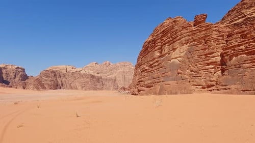 Rear view of eroded sandstone cliffs of Wadi Rum desert